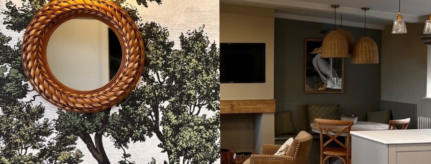 an open plan living room with a tree mural wallpaper